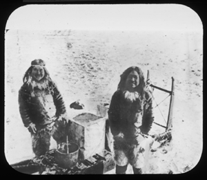 Image of Two Inuit men by sledge. Containers